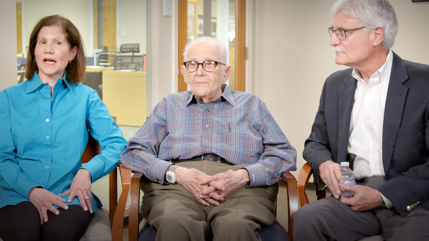 Walter Levy, Julie & Ken Robinowitz are seated in a studio setting telling the story of establishing their fund.